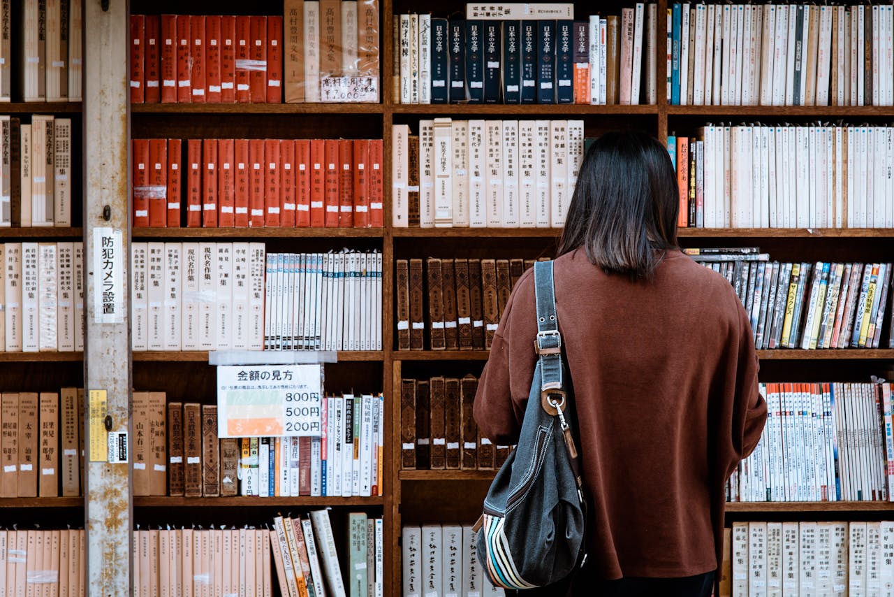 Services-02 Woman browsing books at a library in Nagano, Japan. Explore knowledge and literature.